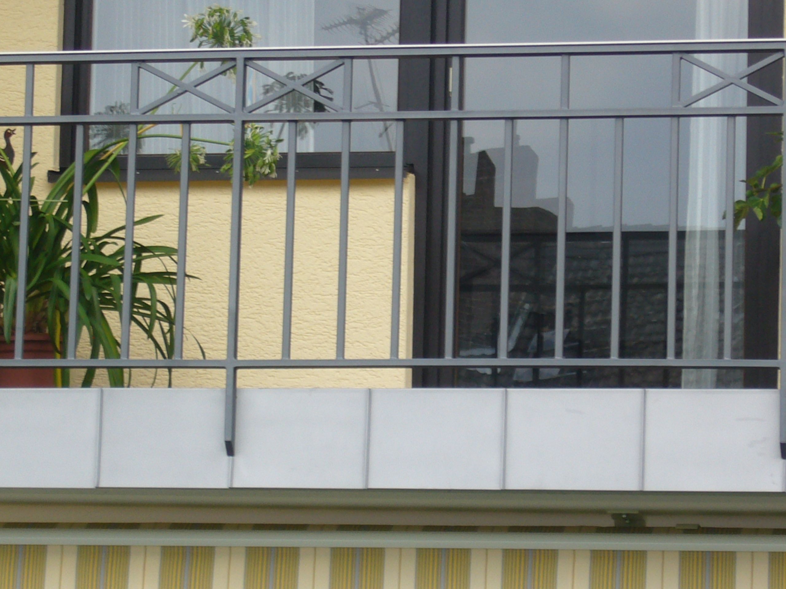 Geländer aus grauen Metallstreben mit Kreuzen als Verzierung